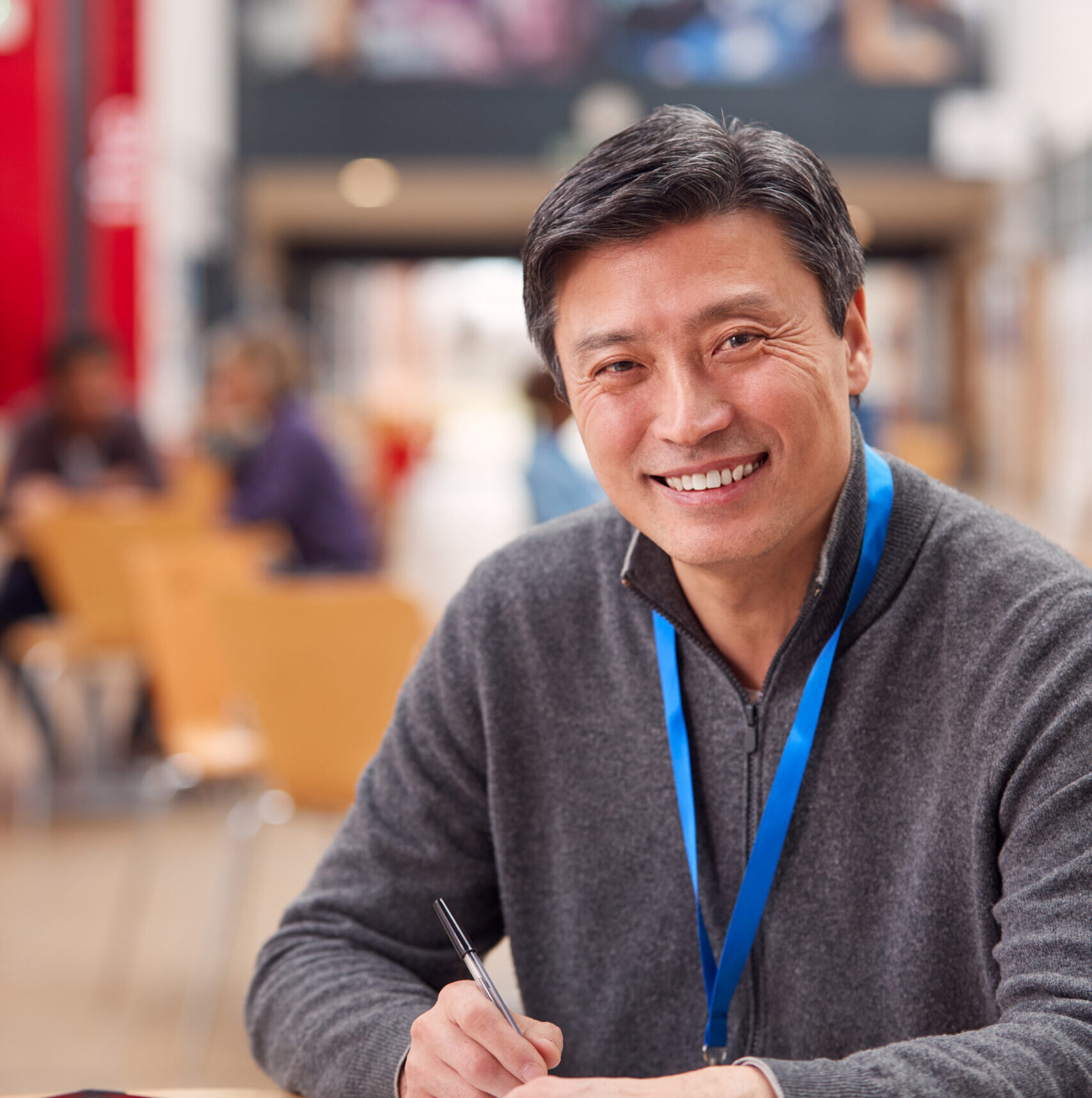 Smiling private school marketing and communications administrator smiling in a classroom