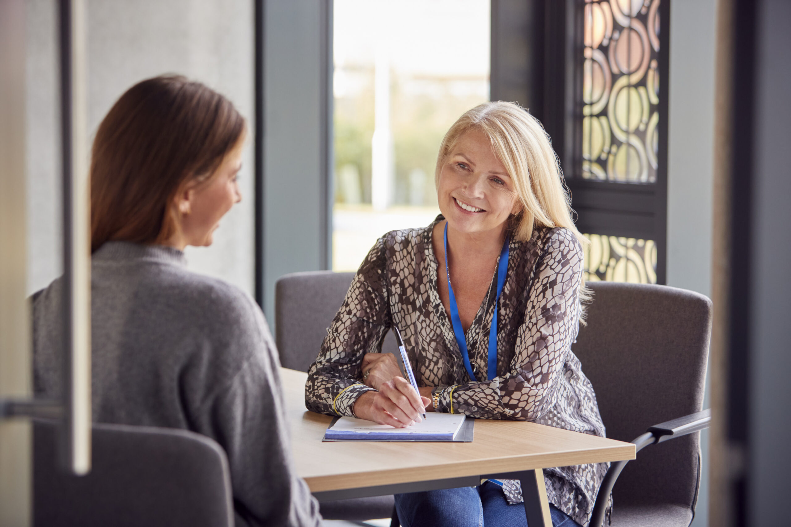 An enrollment director talking with a prospective family at a private school