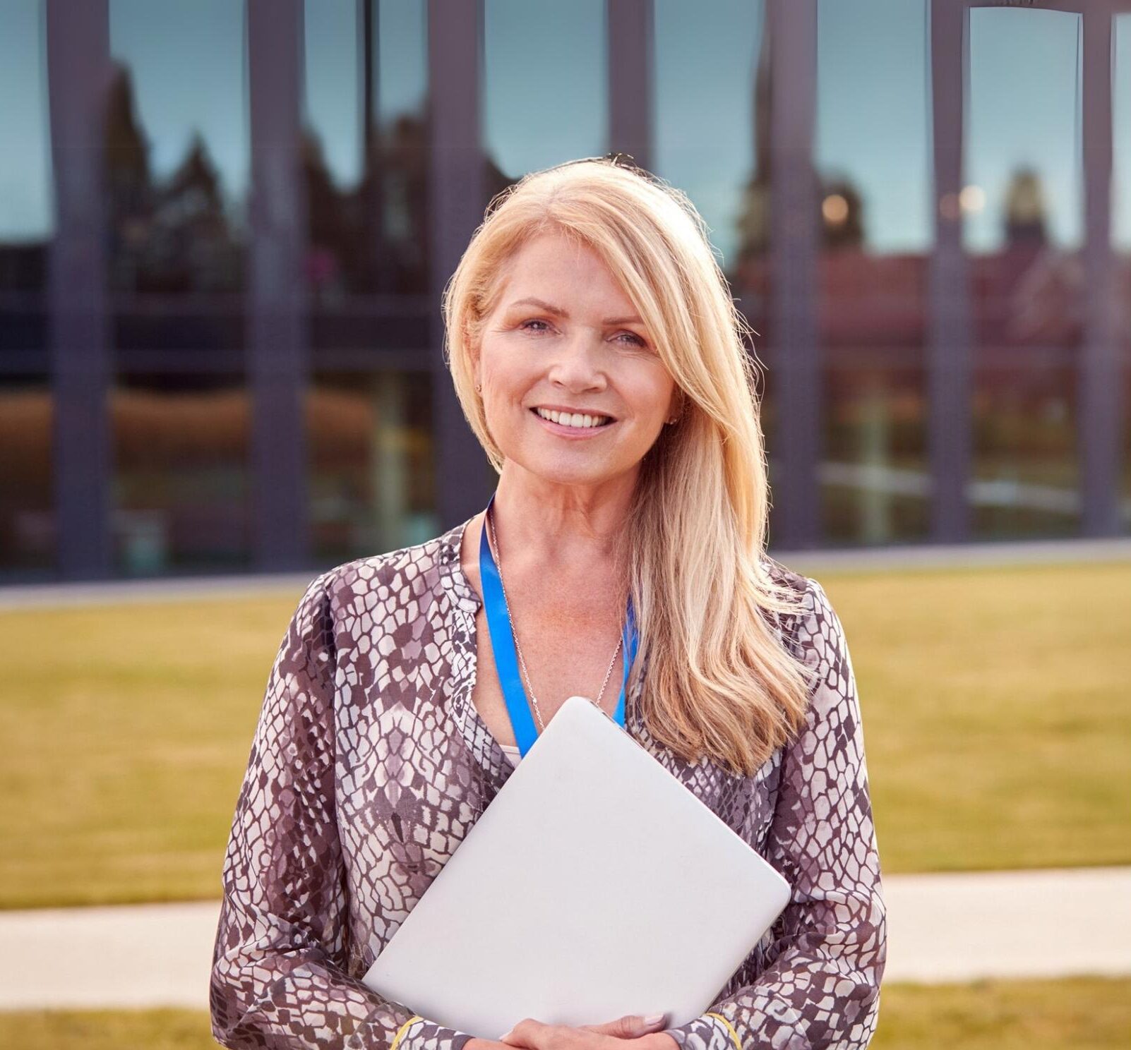 An enrollment director at a private school smiling while outside